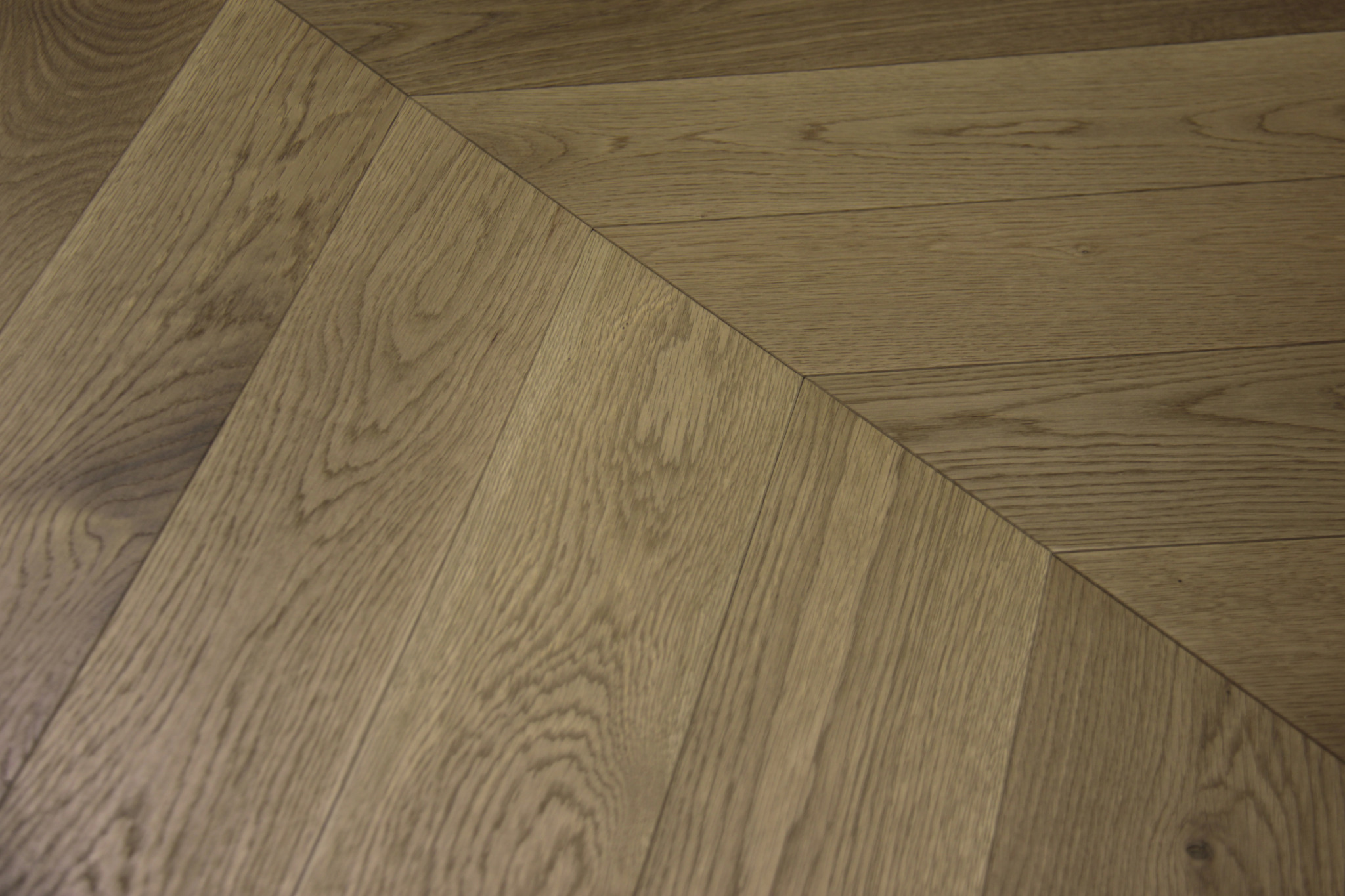 Close-up miter detail — natural oak corner geometry.