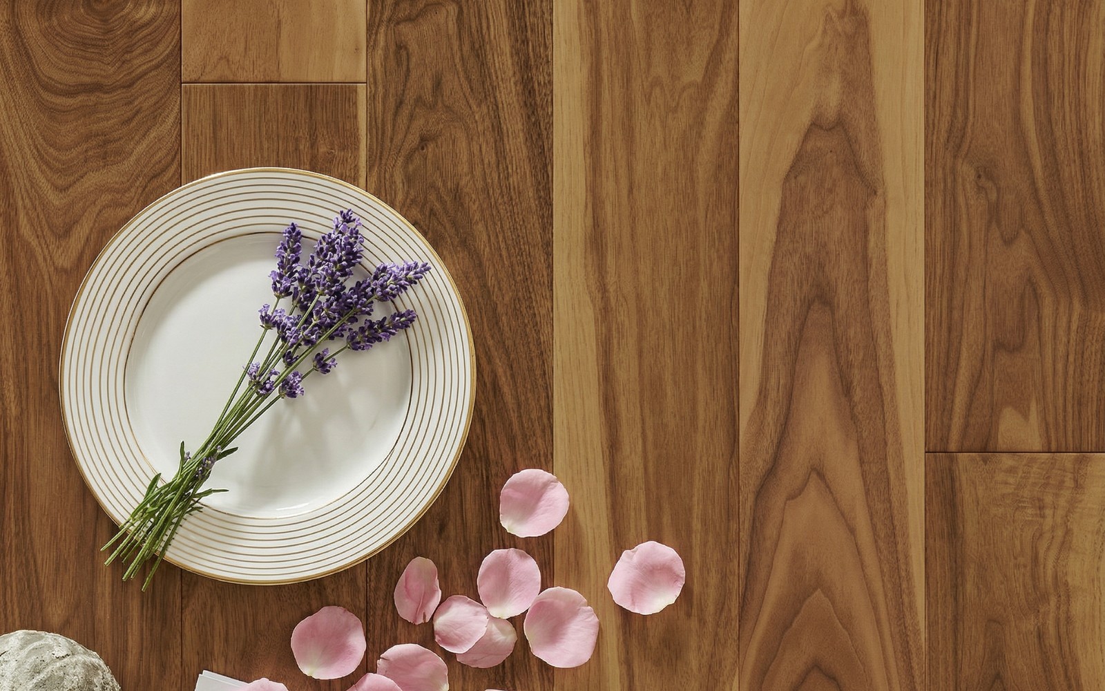 Luxury plank close-up with porcelain plate and petals