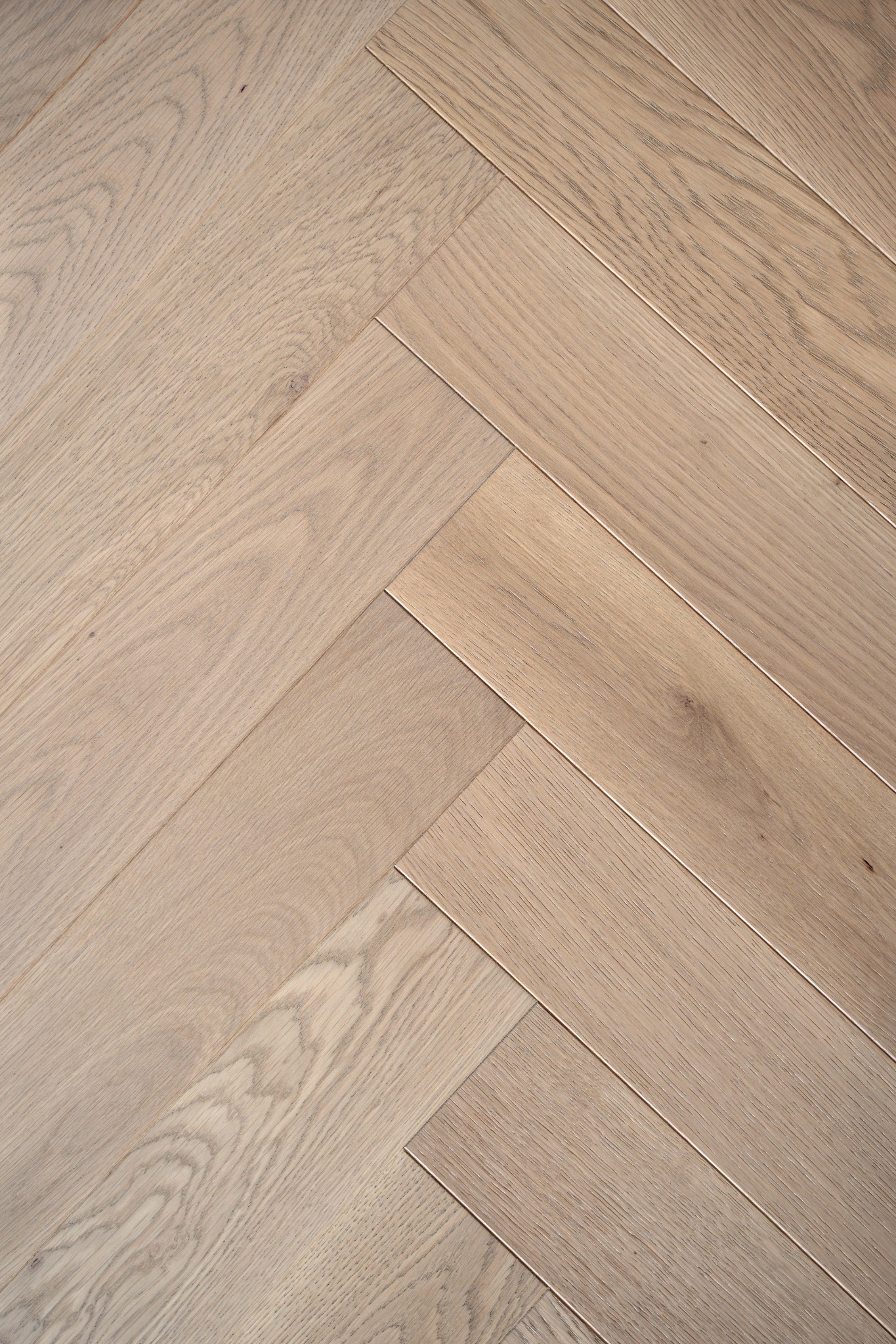 Close-up surface detail — natural oak herringbone.